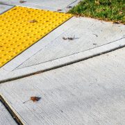 Closeup of a sidewalk with an ADA-accessible curb.